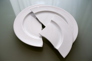 white broken plate on glass table