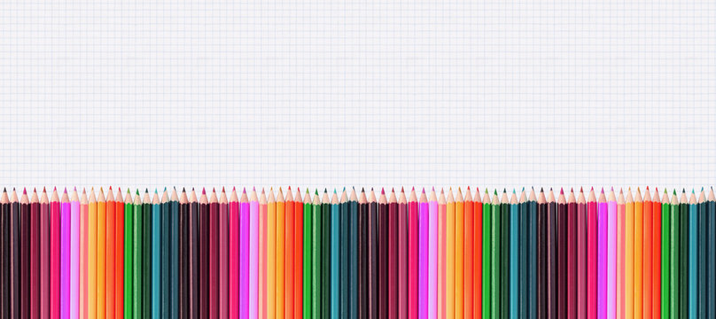 bannière de crayons couleurs, fond papier quadrillé 