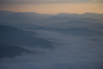 Layer of mountains and mist during sunset