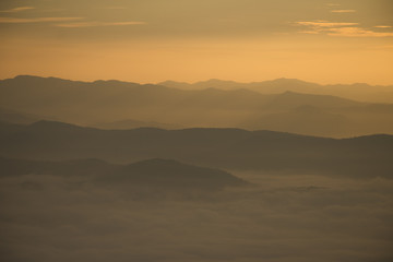Layer of mountains and mist during sunset