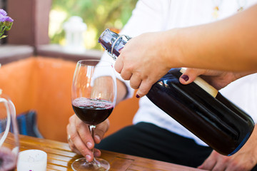 Girl pouring wine to her boyfriend