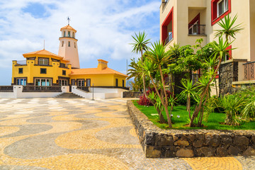 Square with lighthouse building on coastal promenade, Madeira island, Portugal