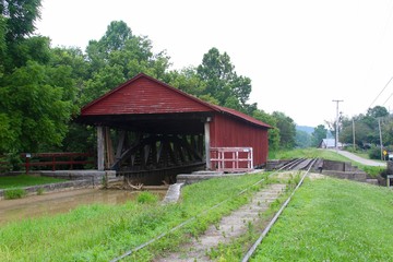 The old red covered bridge in the country.