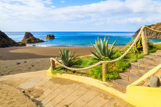 View of beautiful Prainha beach with tropical plants in foreground near Canical town, Madeira island, Portugal