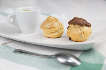 bignè and coffee on white dish