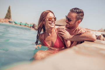 Fototapeta premium Couple relaxing in swimming pool
