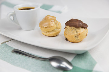 bignè and coffee on white dish