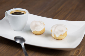 Fototapeta na wymiar bignè and coffee on white dish
