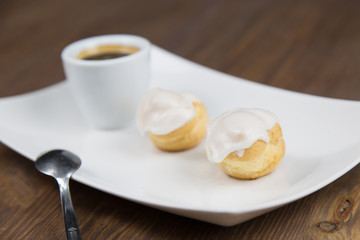 bignè and coffee on white dish