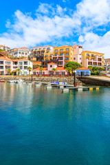 Fototapeta na wymiar View of sailing marina with colourful houses near Canical town on coast of Madeira island, Portugal