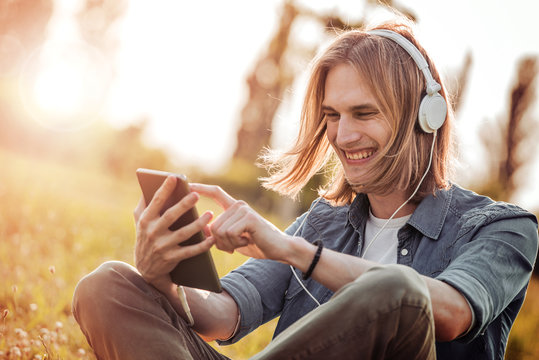 Man using tablet to listen to music.