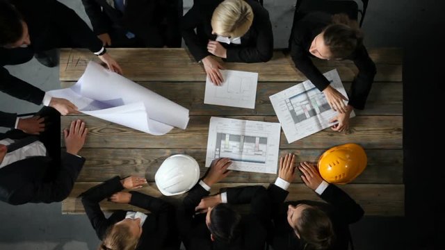 Business people with construction blueprint