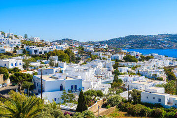 A view of typical Greek apartment buildings in Mykonos town with sea in background, Cyclades islands, Greece