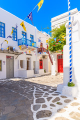 MYKONOS TOWN, GREECE - MAY 17, 2016: Typical street of beautiful Mykonos town with white and blue Greek architecture, Cyclades islands, Greece.