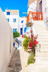 Typical street of beautiful Mykonos town with white and blue Greek architecture, Cyclades islands, Greece
