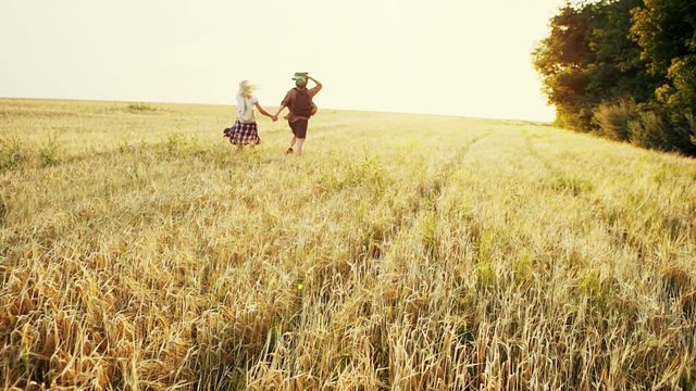 Couple enjoying outdoors in a wheat field.