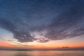Naklejka na ściany i meble dramatic sky and clouds sunrise over tropical sea in phuket thailand