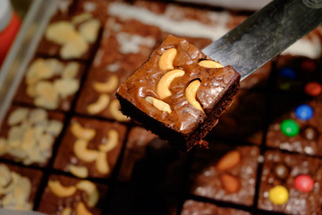 Chocolate brownie with cashew nut on spatula