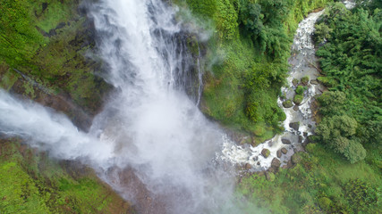 Fototapeta premium Beautiful waterfall.Tad Fan Waterfall in southern Laos.It is a place to visit the natural beauty.Mountain forest waterfall landscape.Top view,Aerial view,waterfall amazing nature background,Rainforest