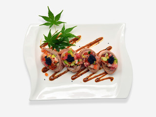 Salmon roll special (caviar roe, salmon roe, maguro, otoro, salmon, avocado) in white plate on white background