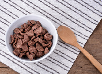 Chocolate cereal in white bowl for breakfast