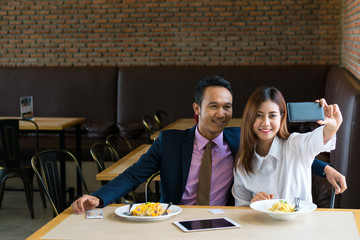 Couple photographed in a restaurant.