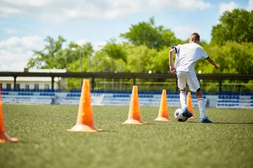 Deurstickers Boy Training for Football Game © Seventyfour