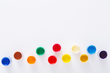 Artist workplace, set of color paints on white