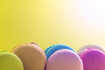 Macaroon. The bright colored rolls, cookies. The background substrate.