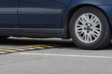 car driving through a speed bump close-up