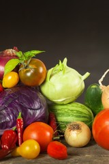 Different types of fresh vegetables on a wooden table. Harvesting vegetables on a farm. Healthy food.