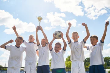 Fototapeten Boys Football Team Winning Champions Cup © Seventyfour