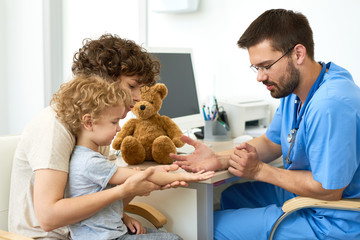 Pediatrician Working with Child in Office