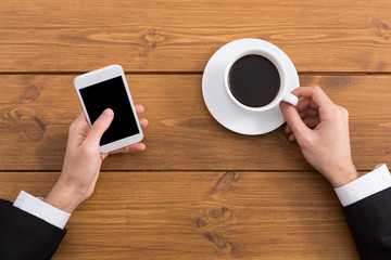Man using smartphone in coffee shop, close-up