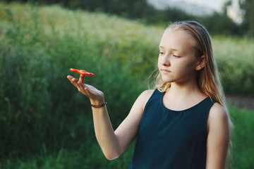girl holding popular fidget spinner toy