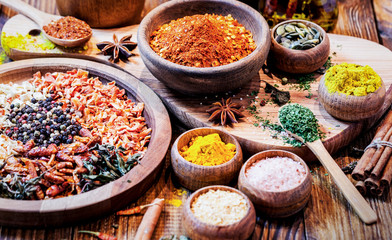 Spices and Herbs on Wooden Background