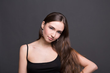 Young woman studio portrait on dark background