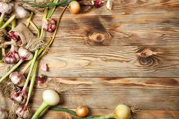 Foto op Plexiglas Fresh vegetables, garlic and onions on a rustic wooden background. View from above. © denisk999