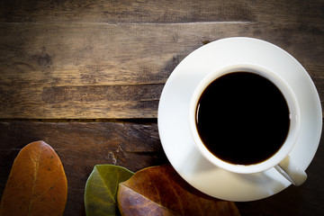 Autumn coffee on wooden background
