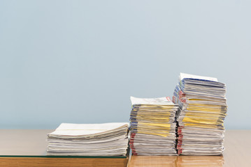 stack of documents on desktop in office.