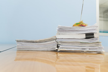 stack of documents on desktop in office.