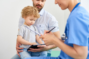 Little Boy with Tablet at Doctors Office