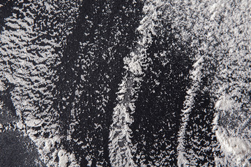 White flour on black background, abstract texture