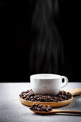 coffee cup and coffee bean in wooden spoon