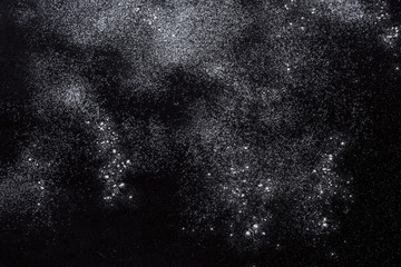 Baking concept on black background, sprinkled flour with copy space