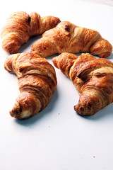 freshly baked croissants on white board, bakery concept