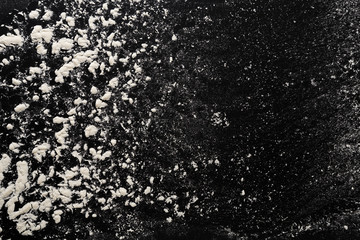 Baking concept on black background, sprinkled flour with copy space