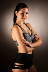 Active young fit woman pose in studio