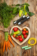 Sport and diet. Fresh vegetables. Healthy lifestyle. Rustic wooden background.