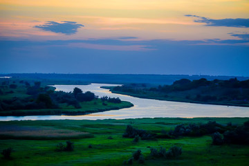 Naklejka premium Beautiful sunset over river bend